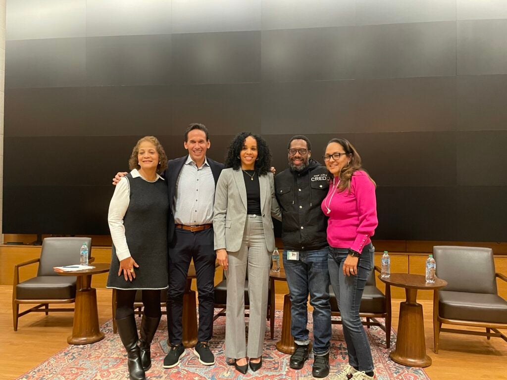 Professor Jasmine Tyler, director of the Policy Innovation Lab at the McCourt School of Public Policy, Dr. Andrea Headley, director of the Evidence for Justice Lab, Professor Marc Howard, director of the Georgetown University Prisons and Justice Initiative, and Tiffany Johnson Cole Esq., attorney at Law Offices of Robert Simms Thompson, PC all stand on a stage side to side.